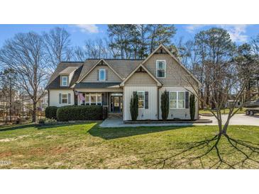 Charming home featuring manicured landscaping, complemented by a well-maintained lawn at 1046 Lawrence Rd, Wake Forest, NC 27587