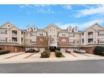 Inviting multi-Gathering exterior with manicured landscaping and private garages offers convenient and stylish living at 10511 Rosegate Ct # 203, Raleigh, NC 27617