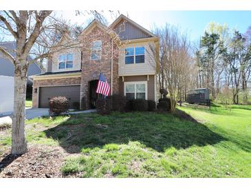Charming two-story home with a manicured lawn and beautiful stone and siding exterior details at 2144 Waterview Dr, Graham, NC 27253