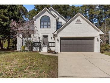 Charming, two-story brick home boasting a beautiful yard and a two-car garage at 2613 Coxindale Dr, Raleigh, NC 27615