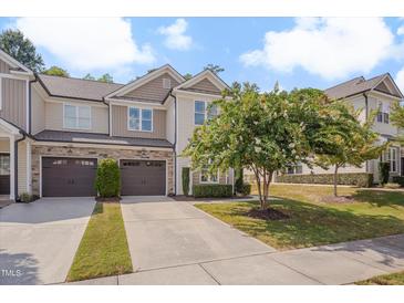Charming townhome featuring a two-car garage, manicured landscaping, and a welcoming front facade at 300 Mariah Towns Way, Garner, NC 27529