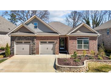 Beautiful brick home featuring an attached two-car garage and manicured landscaping at 310 Macallan, Burlington, NC 27215