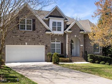 Charming two-story brick home with a well-manicured lawn and attached two-car garage at 314 Montelena Pl, Cary, NC 27513