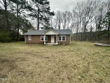 Charming single-story brick home with a well-maintained yard surrounded by mature trees at 4989 Nc 217, Erwin, NC 28339