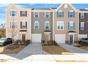 Inviting townhomes with manicured lawns, driveways, and garages for convenient parking at 515 Autumn Cure Ct, Fuquay Varina, NC 27526