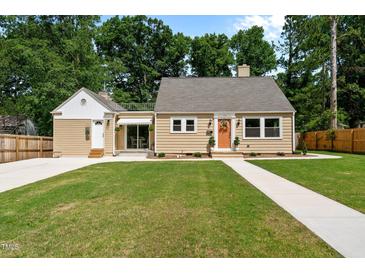 Charming single-Gathering home with a well-maintained front yard and inviting, bright colored front door at 518 W Chisholm St, Sanford, NC 27330