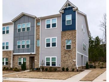 Modern townhome featuring a brick and gray siding exterior at 730 Firebrick Drive Dr, Cary, NC 27519