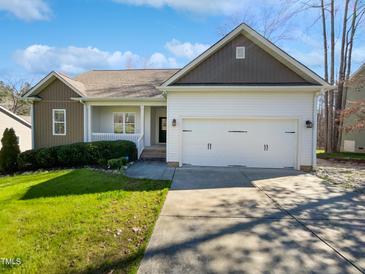Charming home featuring a two-car garage, a cozy porch, and a well-maintained lawn at 80 Somerset Dr, Franklinton, NC 27525
