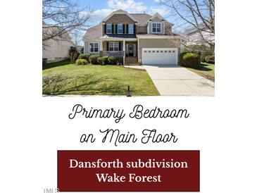 Charming two-story home with a well-manicured lawn and inviting front porch at 9117 Cornwell Dr, Wake Forest, NC 27587