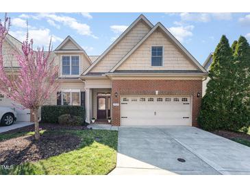 Charming two-story home with a brick and shingle facade, well-maintained lawn, and a two-car garage at 109 Aisling Ct, Cary, NC 27513