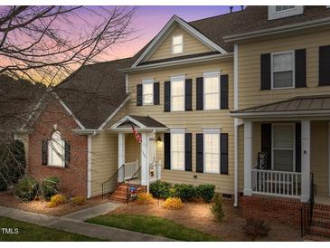 Charming two-story home features a classic design with black shutters and a welcoming front porch at 1203 Fairview Club Dr, Wake Forest, NC 27587