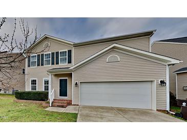 Charming two-story home with a two-car garage, manicured front lawn, and beautiful architectural details at 128 Chownings Dr, Sanford, NC 27330