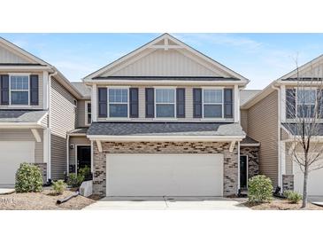Charming two-story townhome featuring a two-car garage, brick accents and dark shutters at 131 Explorer Dr # 257, Morrisville, NC 27560