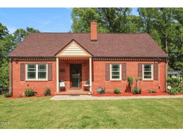 Charming brick home featuring a well-manicured lawn and classic architectural details at 132 Lord Ashley Rd, Raleigh, NC 27610