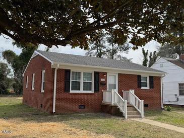 Charming brick home featuring a well-maintained front yard and inviting entrance at 1421 Deer Crossing Ct, Henderson, NC 27536