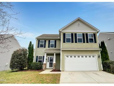 Charming two-story home featuring a two-car garage, well-maintained lawn, and welcoming entrance at 1501 Copper Cir, Mebane, NC 27302