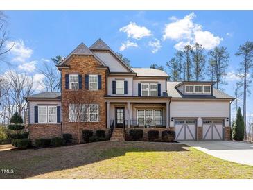 Beautiful two-story home with stone accents, neutral siding, and a well-manicured lawn at 1705 Yates Pond Way, Raleigh, NC 27606