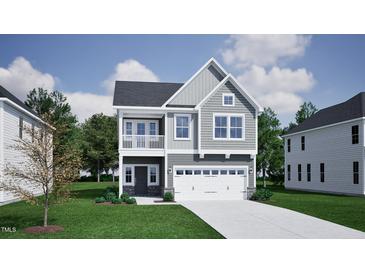 Charming two-story home with gray siding, a balcony, an attached two-car garage, and well-maintained landscaping at 247 Meadowbark Bnd # 29, Garner, NC 27529