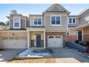 Charming townhome with brick accents, a single-car garage, and inviting front door at 2822 Casona Way, Raleigh, NC 27616