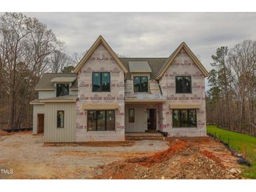 Two-story home featuring multiple windows and a modern design in the process of being built at 2916 Frances Marie Ln, Raleigh, NC 27603