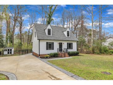 Charming home featuring a well-manicured lawn, tidy landscaping, and a welcoming driveway at 305 Dickens Rd, Fuquay Varina, NC 27526