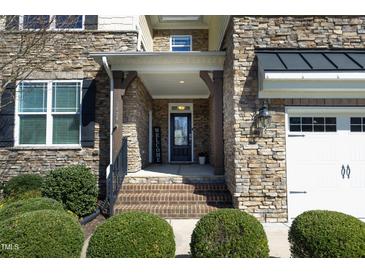 Inviting front entrance with stone facade, brick steps, and a welcoming 'Welcome' sign at 5421 Downton Grove Ct, Fuquay Varina, NC 27526