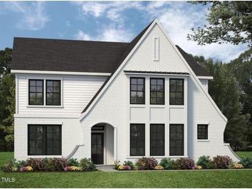 Charming two-story white brick home with a black roof, complemented by colorful flowerbeds and lush green lawn at 68 Alex Farm Ct # 23, Zebulon, NC 27597