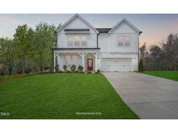 Charming two-story white farmhouse with well-maintained lawn and a two-car garage at 69 Alex Farm Ct # 21, Zebulon, NC 27597