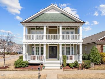 Charming two-story home with inviting double porches, beautiful landscaping, and a welcoming entryway at 1086 Tender Dr, Apex, NC 27502