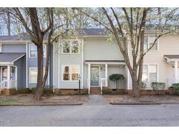 Charming townhome featuring a landscaped front yard and a welcoming covered front porch at 1515 Edgeside Ct, Raleigh, NC 27609