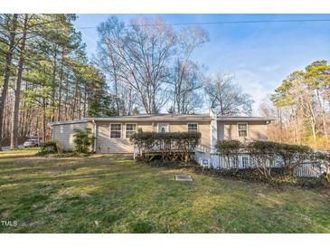 Cozy home with a well-maintained lawn and mature trees, offering a peaceful suburban setting at 3012 Optimist Farm Rd, Apex, NC 27539