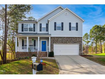 Charming two-story home with stone accents, inviting front porch, and well-manicured landscaping at 101 Whitney Ln, Durham, NC 27713