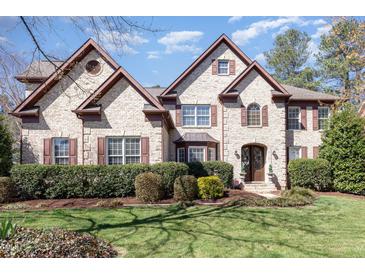 Beautiful, two-story brick home with well-manicured landscaping and a charming, inviting facade at 10841 Round Brook Cir, Raleigh, NC 27617