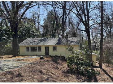Charming single-story home featuring a well-maintained yard and mature trees at 123 Barclay Rd, Chapel Hill, NC 27516
