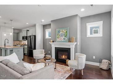 Inviting living room featuring a fireplace, modern furniture, and an open floor plan at 1312 Big Falls Dr, Wendell, NC 27591