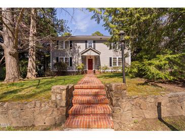 Charming two-story home with a brick pathway leading to the front door at 212 W University Dr, Chapel Hill, NC 27516