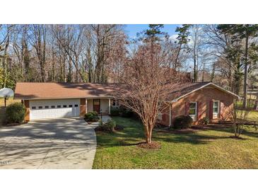 Charming brick home featuring an attached two-car garage and a well-manicured lawn at 3001 Blanche Dr, Burlington, NC 27215