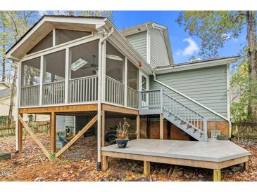 Lovely screened porch featuring skylights and wooden deck, perfect for outdoor relaxation and entertaining at 4117 Olde Coach Rd, Durham, NC 27707