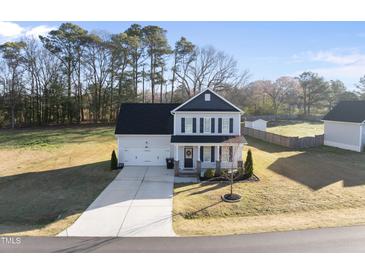 Charming two-story home with a well-manicured lawn and a two car attached garage at 54 Silverleaf Dr, Wendell, NC 27591