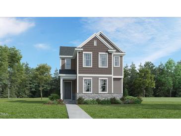 Charming two-story home with a combination of stone and wood siding at 5648 Cayden Cove Dr, Wendell, NC 27591