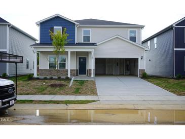 Charming two-story home with a two-car garage and a cozy front porch entrance at 591 White Birch Ln, Angier, NC 27501