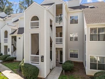 Exterior of a multi-level condo building with balconies and well-maintained landscaping at 6001 Winterpointe Ln # 204, Raleigh, NC 27606