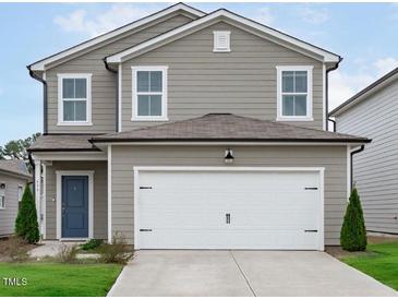 Charming two-story home with a two car garage, neutral siding, and well-maintained landscaping at 656 Dallas Rose Dr, Wendell, NC 27591