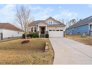 Charming single-Gathering home featuring a two-car garage and a beautifully landscaped front yard at 105 Olde Liberty Dr, Youngsville, NC 27596