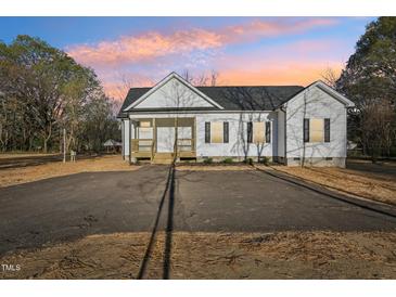 Charming one story home features a welcoming front porch and spacious front yard at 111 Faucette Ave, Burlington, NC 27215