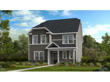 Charming two-story home featuring gray siding, stone accents, and a covered front porch, set amidst a landscaped yard at 1244 Hardin Hill Ln, Knightdale, NC 27545