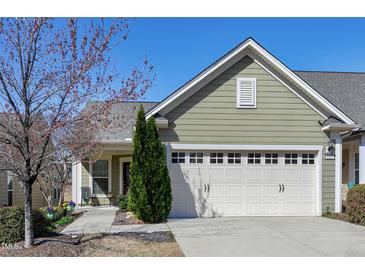 Charming home featuring an attached garage, well-maintained lawn, and inviting curb appeal at 1407 Palmer Hill Dr, Durham, NC 27703