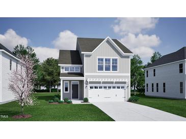 Charming two-story home with gray siding, a two-car garage, and beautifully landscaped front yard at 239 Meadowbark Bnd # 27, Garner, NC 27529