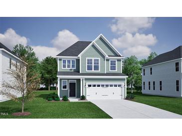 Charming two-story home with a front-facing two car garage, black front door and nicely manicured lawn at 243 Meadowbark Bnd # 28, Garner, NC 27529