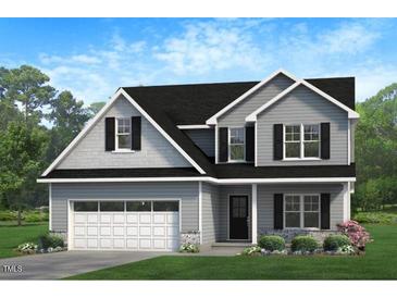 Charming two-story home featuring a two-car garage and welcoming front porch at 274 Yardley Dr, Smithfield, NC 27577